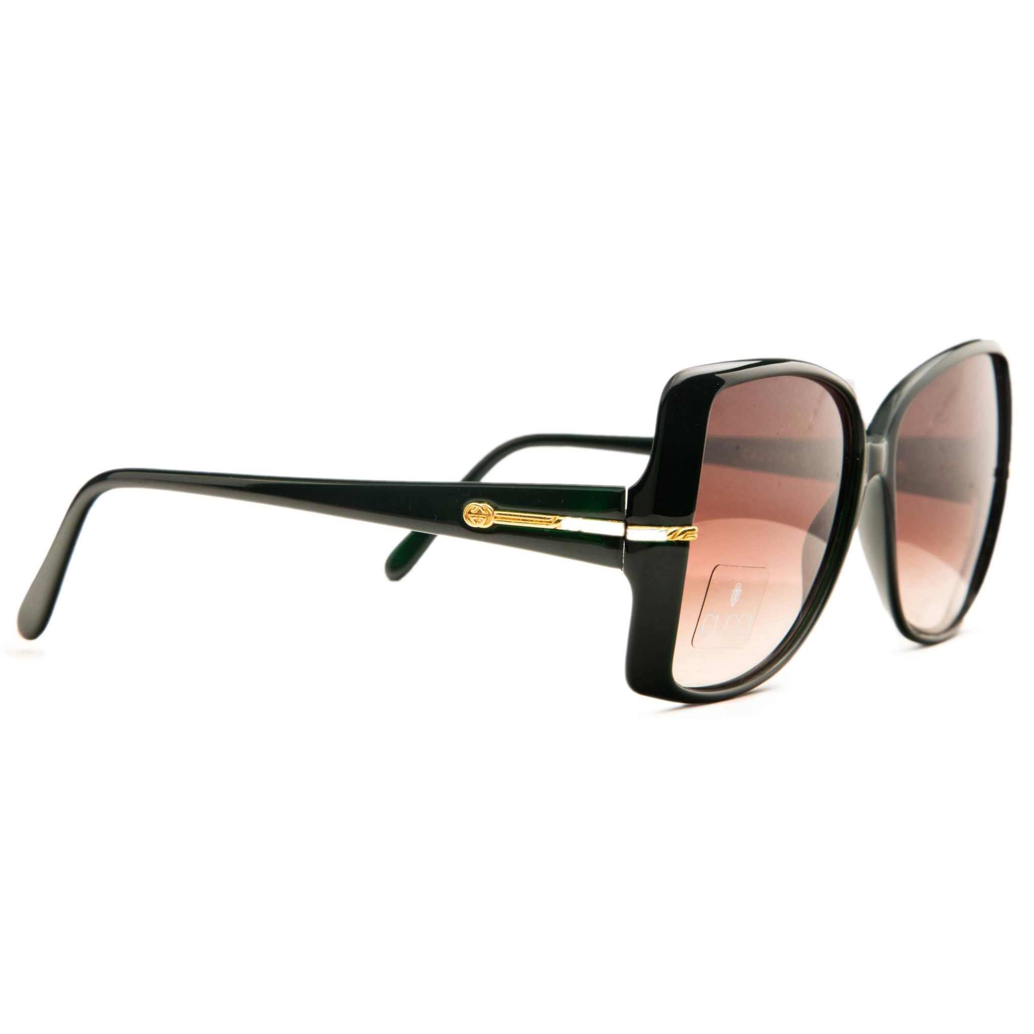 Authentic Vintage Gucci Square 42215 oversized sunglasses designed for women, featuring a glossy dark green frame and brown lenses with 100% UV protection