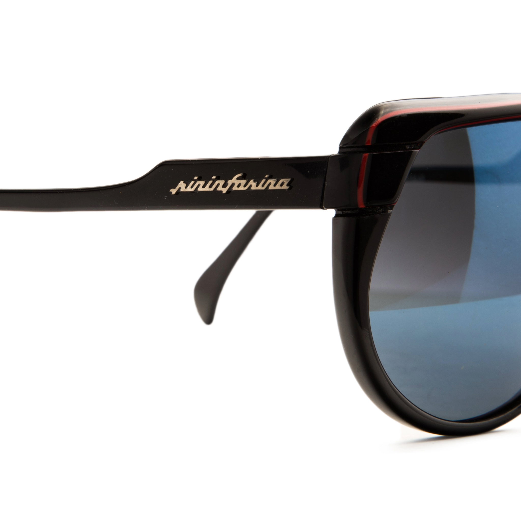 Close-up of the black and red frame and blue Revo lenses of vintage Persol Pininfarina Flat Brow 811 sunglasses