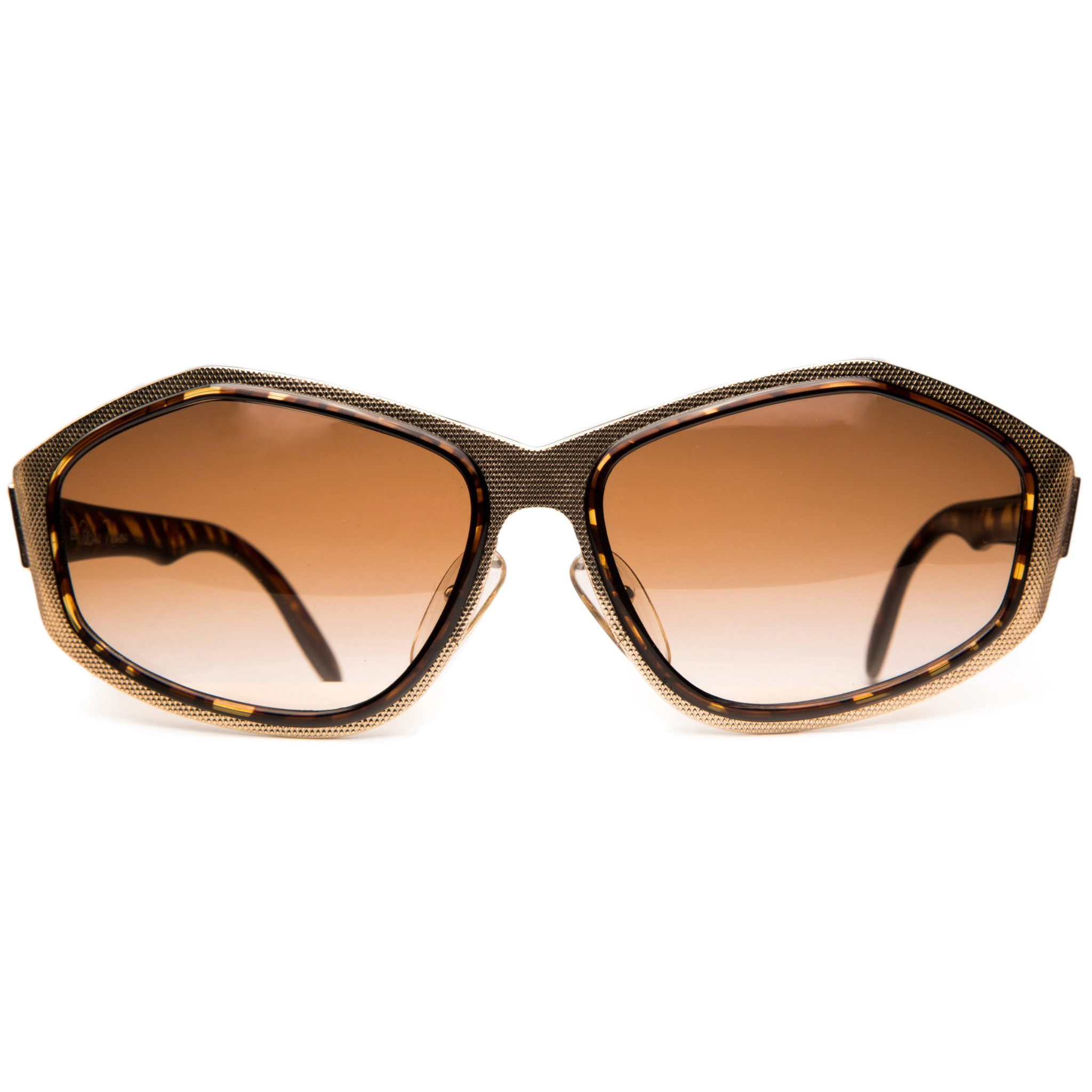 Paloma Picasso Oval 3715: Gold and black oval sunglasses with sleek design